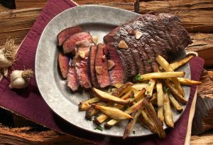 photo of steak and french fries on gray plate